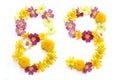 number eighty-nine 89, eight 8 and nine 9 made from freshly picked yellow and pink flowers.