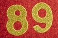 Number eighty-nine yellow color over a red background. Anniversary.