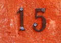 Number fifteen formed from two digits one and five on the wall Royalty Free Stock Photo