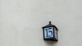 Number fifteen in a wall of a house, detail of a number of information, old number. Royalty Free Stock Photo