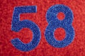 Number fifty-eight blue color over a red background. Anniversary