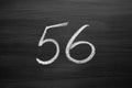 Number fifty six enumeration written with a chalk on the blackboard