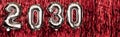 2030 number figure balloons on a red background. New Year composition. Royalty Free Stock Photo