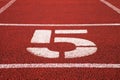 Number five. Big white track number on red rubber racetrack. Gentle textured running racetracks in stadium. Royalty Free Stock Photo