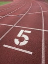 Number five. Big white track number on run rubber racetrack. Royalty Free Stock Photo