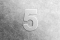Number five embossed on a scratched metal background Royalty Free Stock Photo