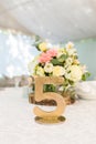 Number five at table for guests on wedding hall. Gold wedding table number. Royalty Free Stock Photo