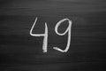 Number forty nine enumeration written with a chalk on the blackboard