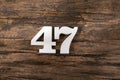 Number forty seven 47 - White Piece on Rustic Wood Background