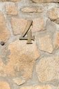Number four made of metal on a stone wall. Royalty Free Stock Photo
