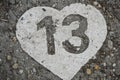 Number 13 in a heart painted on concrete