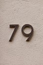 Number 79 house number on white wall