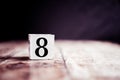 Number 8 isolated on dark background- 3D number eight isolated on vintage wooden table