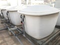 Number of 1000 liter capacity water tanks made of glass reinforced plastic kept over concrete bed with necessary Plumbing works