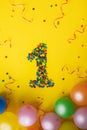 Number 1 made of candies birthday on yellow background. Royalty Free Stock Photo