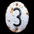 Number 3 made of forged metal on the background fragment of a metal surface with cracked rust.