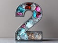A number 2 made out of colorful gems on a table