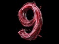 A number 9 made of red liquid on a black background Royalty Free Stock Photo