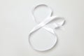 Number 8 made of white ribbon on light grey background, top view. International Women`s day