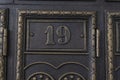 Number 19 on metal door. Old vintage retro copper plate with the number nineteen. Antique mailboxes Royalty Free Stock Photo