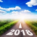 Number of 2018 for New Year concept on country road, field and b Royalty Free Stock Photo