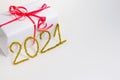 2021 number for New year greeting card. Christmas gift decoration on white background. Golden tinsel. Royalty Free Stock Photo