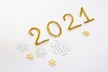 2021 number for New year greeting card. Christmas Party decoration on white background. Golden tinsel and snowflakes. Royalty Free Stock Photo