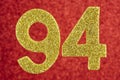 Number ninety-four golden color over a red background. Anniversary.