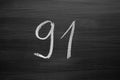 Number ninety one enumeration written with a chalk on the blackboard