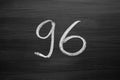 Number ninety six enumeration written with a chalk on the blackboard