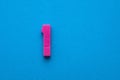 Number one color pink (1) - Plastic digit on blue foamy colored background