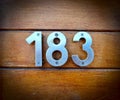183, number 183 on a wooden background, house number, home number, numbres Royalty Free Stock Photo