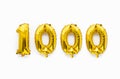 Number 1000 one thousand golden foil balloon party decor on white background, birthday anniversary Royalty Free Stock Photo