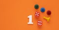 Number 1 with dice and board game pieces - Orange eva rubber background Royalty Free Stock Photo