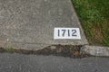 The number 1712 painted on a concrete driveway with a white background Royalty Free Stock Photo