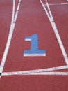 Number 1 painted on running track racing lane with white lines clearly marking lanes
