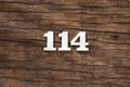 Number 114 - piece on rustic wood background Royalty Free Stock Photo