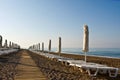 A number of plank beds and umbrellas on a beach Royalty Free Stock Photo