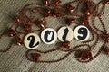 Number 2019 and red bells on the rough background. Space for text. Royalty Free Stock Photo