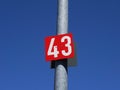 Number 43 on a red poster on the metal pole