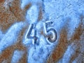 45 number on rusted metal.