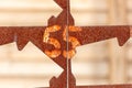 The number 55 on a rusty metal fence