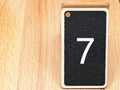 number seven black and white with wooden background