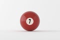 Number seven pool ball resting on white surface