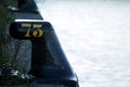 Number seventy three 73 in yellow colour on black iron noray