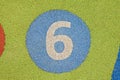 Number six in a multicolored rubber outdoors children\'s playground