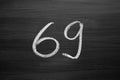 Number sixty nine enumeration written with a chalk on the blackboard Royalty Free Stock Photo