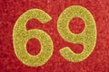 Number sixty-nine yellow color over a red background. Anniversary. Royalty Free Stock Photo