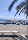 Number of small yacht are docked in the pier and an empty chair in the park , a view from Italy Royalty Free Stock Photo