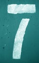 Number 7 in stencil on metal wall in cyan tone Royalty Free Stock Photo